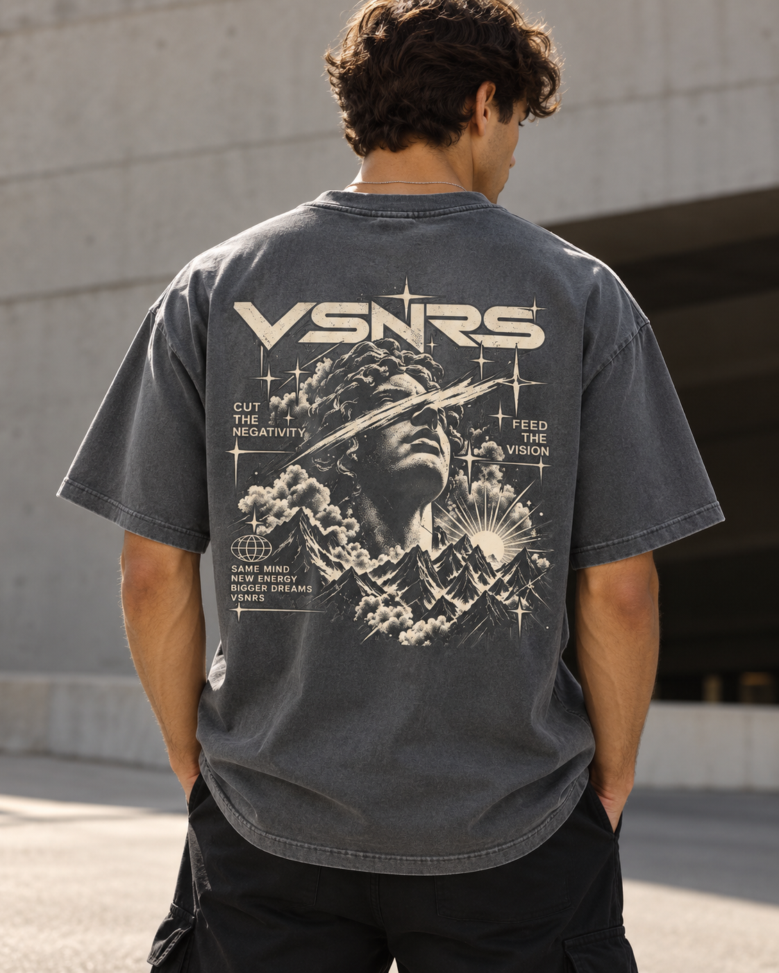 Feed The Vision Tee in a lighter washed grey — model back